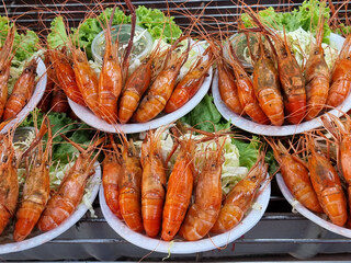 large steamed river prawns arranged neatly and beautifully on a white plate Served with sweet seafood sauce Sour and spicy. To prepare to sell to customers in the market.