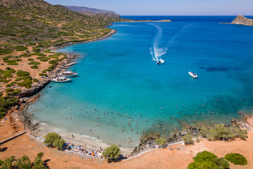 Aerial view of a small beach and clear, blue ocean on the Greek island of Crete