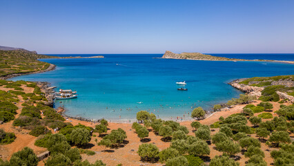 Fototapeta na wymiar Aerial view of the clear waters and hot, dry coastline at a small beach on the Greek island of Crete