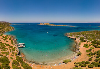 Aerial view of the clear waters and hot, dry coastline at a small beach on the Greek island of Crete