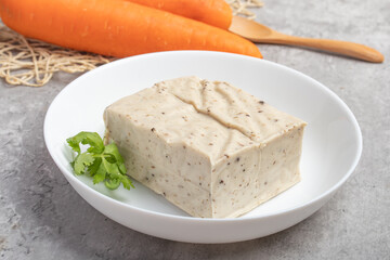 black sesame tofu grains tofu in a white plate