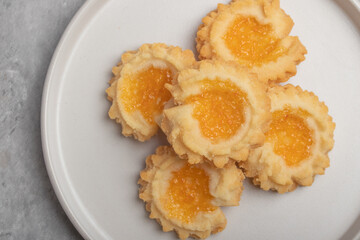 Orange cookies on a white plate