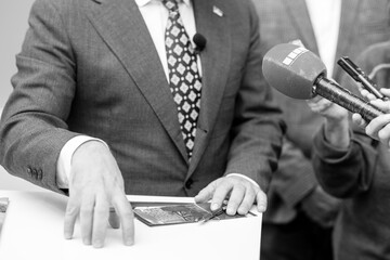 Naklejka premium News or press conference or media interview with businessman, digital voice recorder and microphone in focus