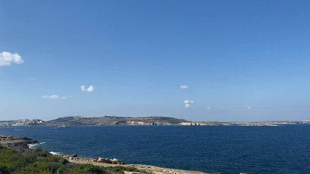 Spring seascape in Qawra, Malta. Calm sea and blue sky with clouds, mediterranean island. High quality FullHD footage