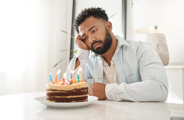 When no one shows up for your birthday. Shot of a young man celebrating his birthday alone at home.