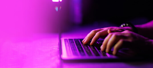 Close-up shot of Man typing on laptop with text free space on the side. Business, computer, coding, e-commerce concept High quality big resolution photo.