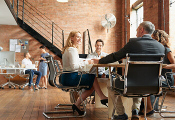 Getting all the best ideas flowing. Shot of a group of businesspeople having a meeting in an office.