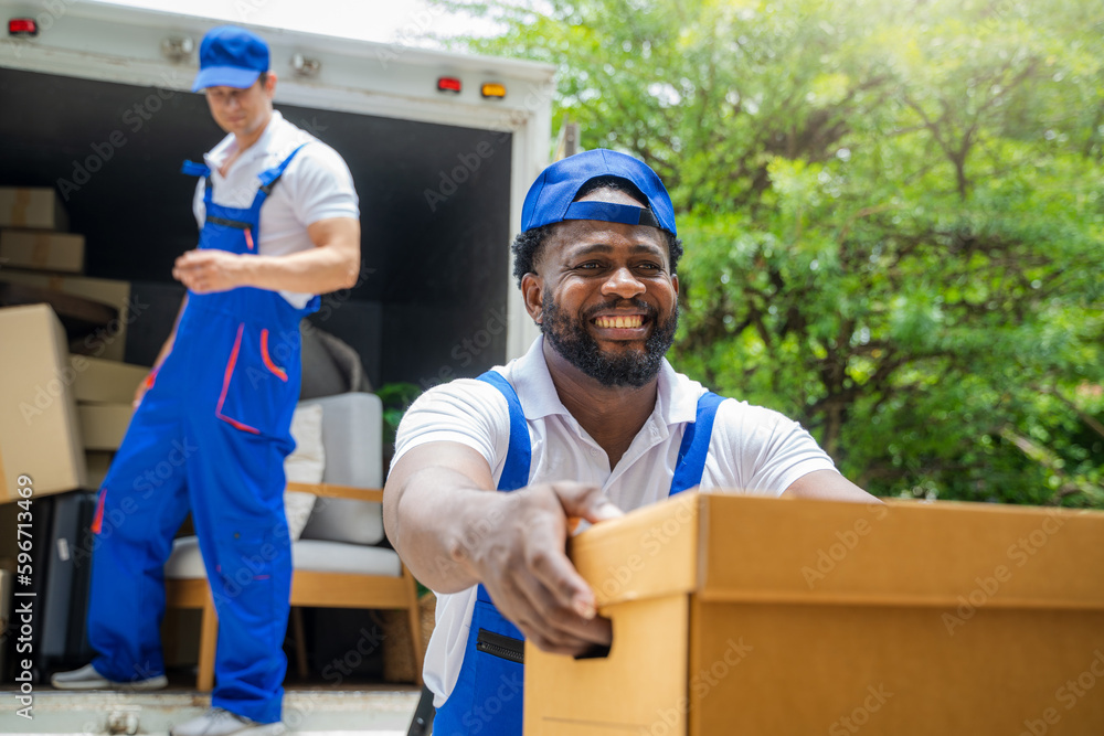 Poster House moving service worker unloading boxes and checking list before sending them to the homeowner.