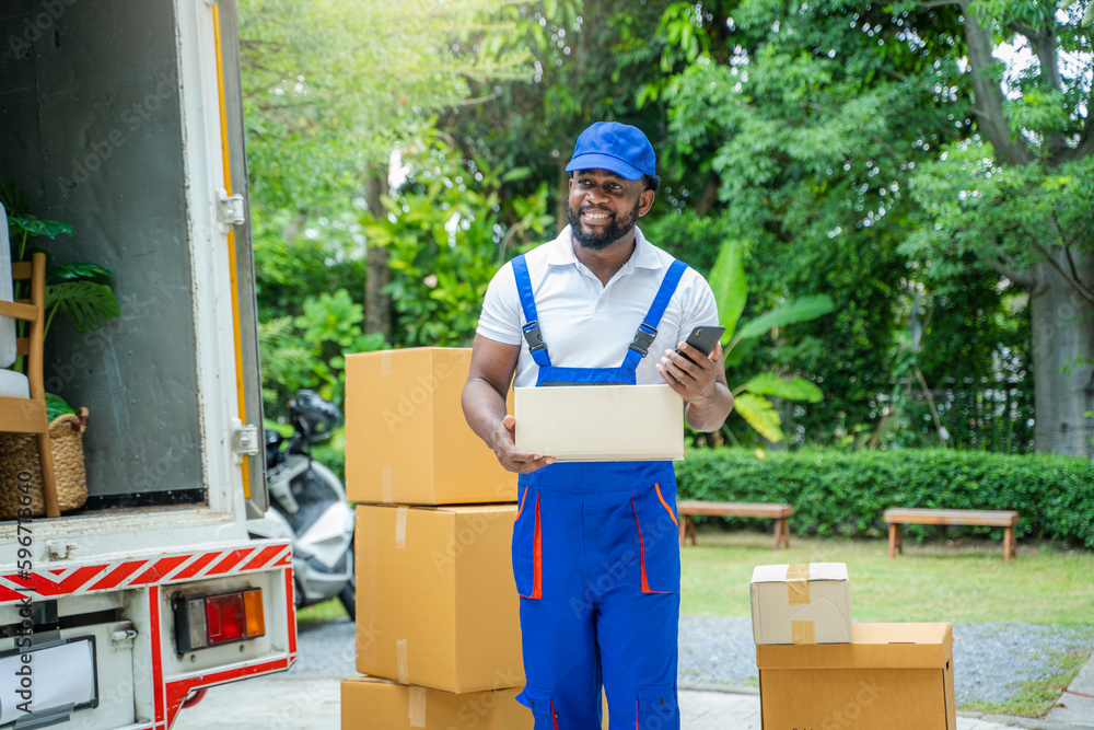 Poster House moving service worker unloading boxes and checking list before sending them to the homeowner.