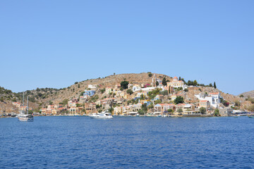 Fototapeta na wymiar A view of the town of Symi island in Greece from the sea, copy space 