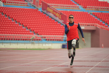 Fototapeta premium athlete runner physically disabled run on track of stadium