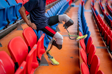 Athlete runner with prosthetic legs at track stadium