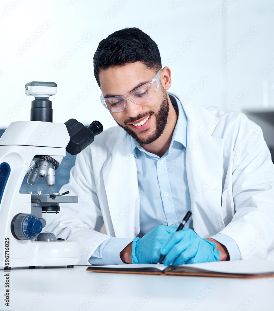 Poster one handsome young mixed race man wearing gloves and a labcoat and looking at medical samples on a m