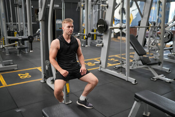 Man doing weight lifting exercises inside the gym