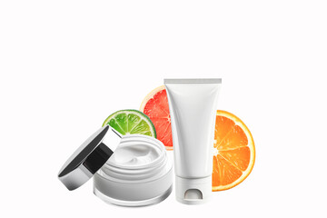 Care cosmetics with high vitamin C content. White empty tube, jar of cream and fruit halves on a...