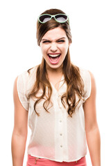Who are you calling crazy. Studio shot of an attractive young woman dressed up in 60s wear and screaming against a white background.