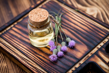 Obraz na płótnie Canvas Canadian thistle, lettuce from hell thistle, California thistle, corn thistle, cursed thistle, field thistle, green thistle Fresh purple flowers on a wooden cutting board at the herbalist's pharmacy.