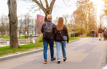 Obraz premium A guy and a girl walk along the path in the city Park 