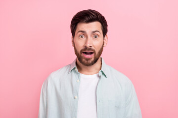 Photo portrait of handsome young guy open mouth astonished shocking news dressed stylish blue clothes isolated on pink color background