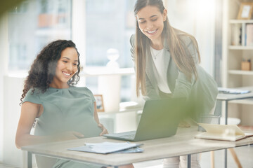 Obraz premium I just need your approval on these before you leave. Shot of two young businesswomen working together on a laptop in an office.