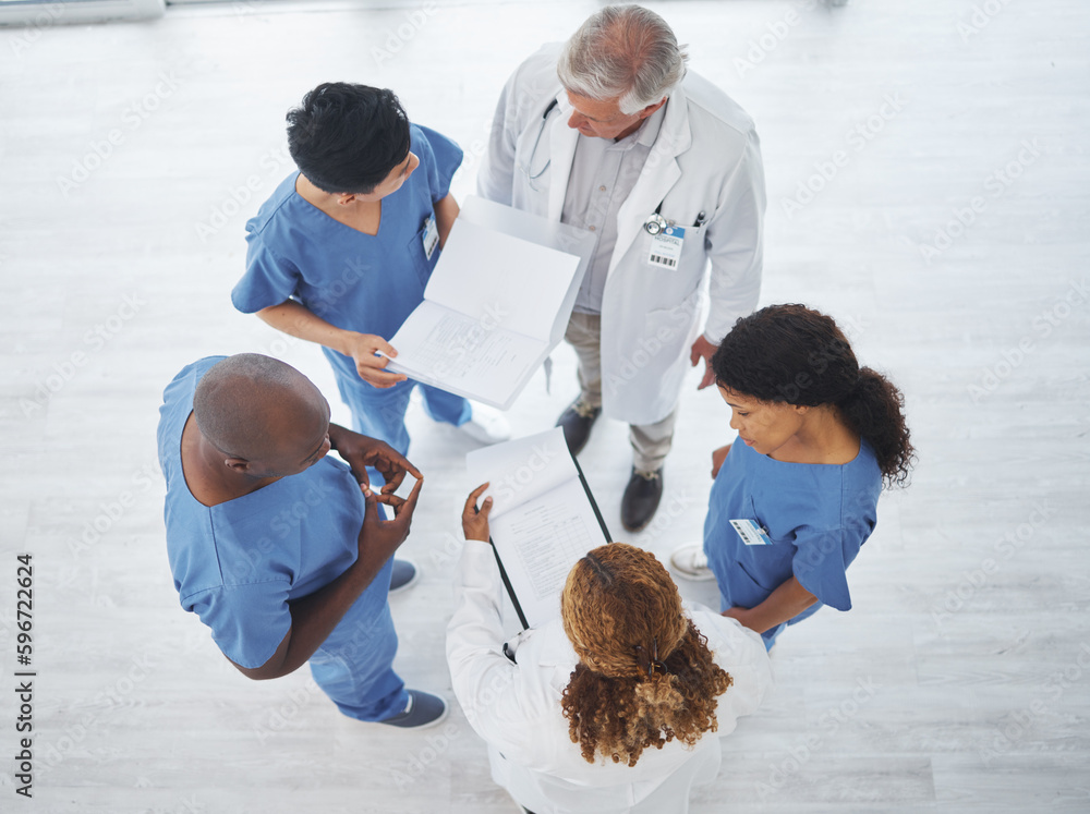 Poster Finding solutions to complex cases from several perspectives. High angle shot of a group of medical practitioners having a discussion together in a hospital.