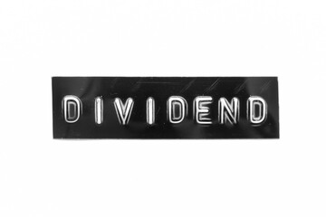 Black color banner that have embossed letter with word dividend on white paper background