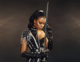Portrait fantasy african american woman warrior holding sword weapon in hand. Dark queen girl in...