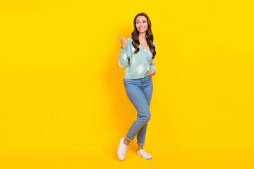 Fototapeta premium Full body portrait of cheerful gorgeous lady look direct finger empty space isolated on yellow color background
