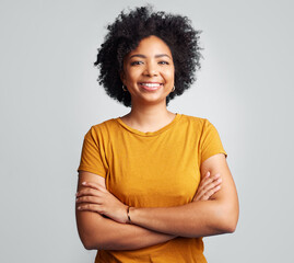 The best thing you can be is to be happy. Studio shot of a beautiful young woman smiling while standing against a grey background. © Nicholas Felix/peopleimages.com