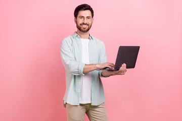 Photo portrait of handsome young guy hold laptop typing coder working dressed stylish blue clothes...