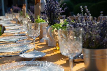 Beautiful outdoor celebration table green background with lavender decoration