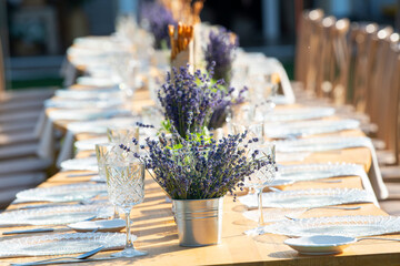 Beautiful outdoor celebration table green background with lavender decoration