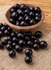 Jabuticabas on a bowl over wooden table
