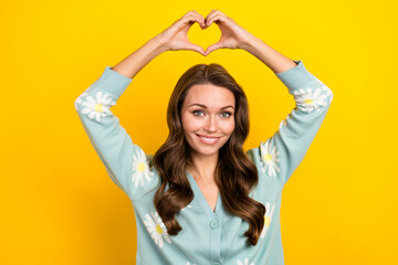 Photo of young positive cheerful lady showing fingers sympathy love symbol wear trendy cardigan...