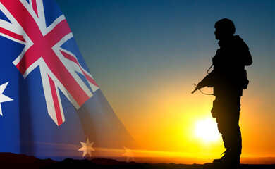 Silhouette of Soldier with Australian flag on background of sunset