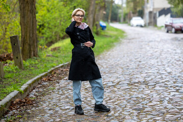 A beautiful blonde girl on a cobbled street