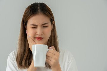 Asian woman feel sensitive teeth after drinking hot, female suffer tooth, decay problems, dental...