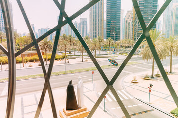 View of the sculpture together in Dubai. Sculpture in Dubai an arab couple dressed in traditional white and black clothes in a characteristic Emirati style: white male dish-dash and black female abaya