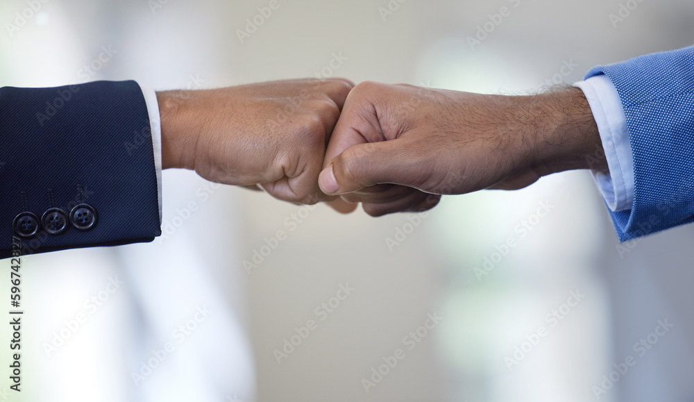 Poster weve got this. closeup shot of two unrecognisable businessmen giving each other a fist bump in an of