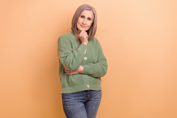 Portrait of thoughtful woman with bob hairstyle wear knit pullover hand on chin think business...