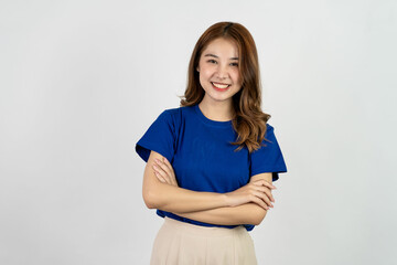 Obraz premium Happy Asian woman in blue t-shirt posing with hands and looking at camera on white background