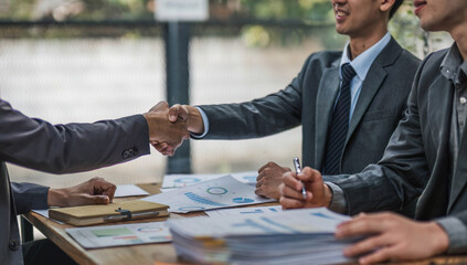 Business handshake for teamwork of business merger and acquisition,successful negotiate,hand shake,two businessman shake hand with partner to celebration partnership and business deal concept.