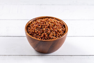 Red pepper seeds bowl. 45 degrees studio shoot on light wooden white background.