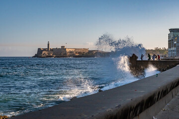 The Malecon waterfront with the three kings castle lighthouse in Havana, Cuba