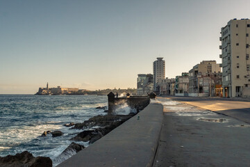The Malecon waterfront with the three kings castle lighthouse in Havana, Cuba