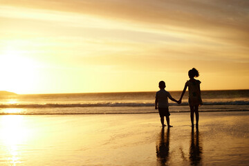 Fototapeta na wymiar Hearts sing of purity. Shot of an adorable brother and sister bonding at the beach.