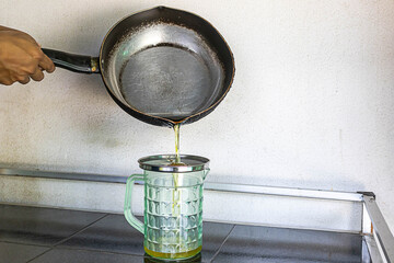 Pour used cooking oil into containers. old or used cooking oil can be recycled into biodiesel.