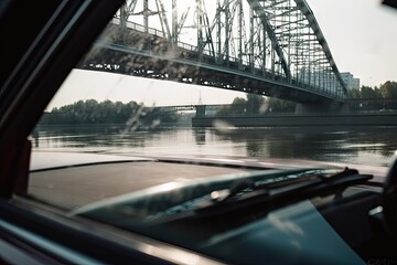 close-up of car window with view of modern bridge crossing the river, created with generative ai