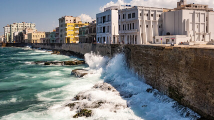 Waves splash on the Malecon sea wall in la Havana Cuba