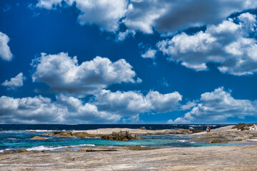 Rocky coast and a deep blue sky with white clouds. William Bay National Park, Western Australia
